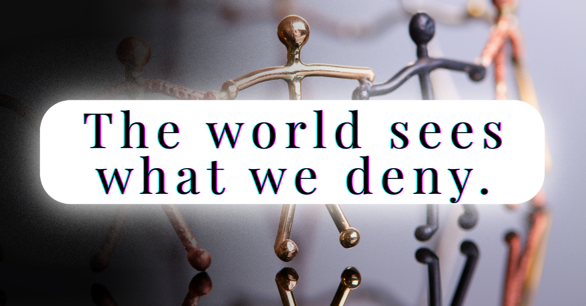 A photograph of multicolored metal stick figures standing hand in hand in a reflective circle. Centered across the image is a white rounded rectangle with bold, glitch-styled text reading: “The world sees what we deny.” The clean, high-contrast design emphasizes clarity, modern urgency, and the tension between perception and denial.