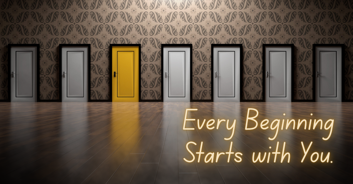 A row of identical gray doors lines a patterned wall, but one door stands out, painted bright yellow and glowing with light. On the wooden floor below, glowing text reads: ‘Every Beginning Starts with You.’ The image symbolizes individuality, new beginnings, and the journey of self-discovery.