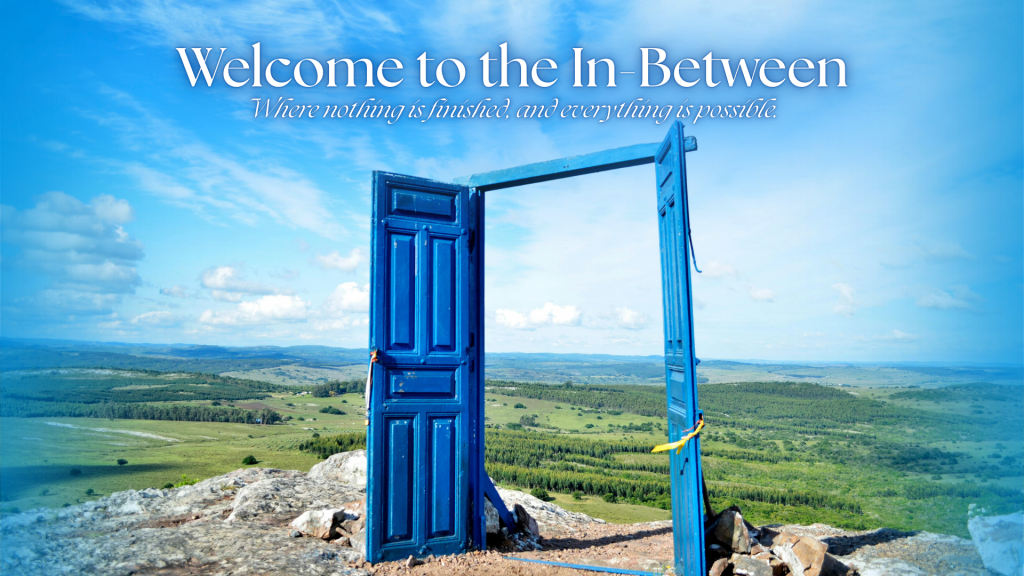 An open blue door standing alone in a wide landscape under a bright sky, symbolizing transition and possibility.