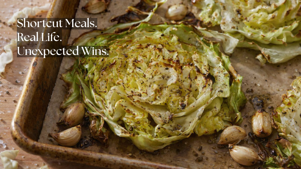 Roasted cabbage steaks with caramelized edges and whole garlic cloves on a baking sheet, overlaid with the words “Shortcut Meals. Real Life. Unexpected Wins.”