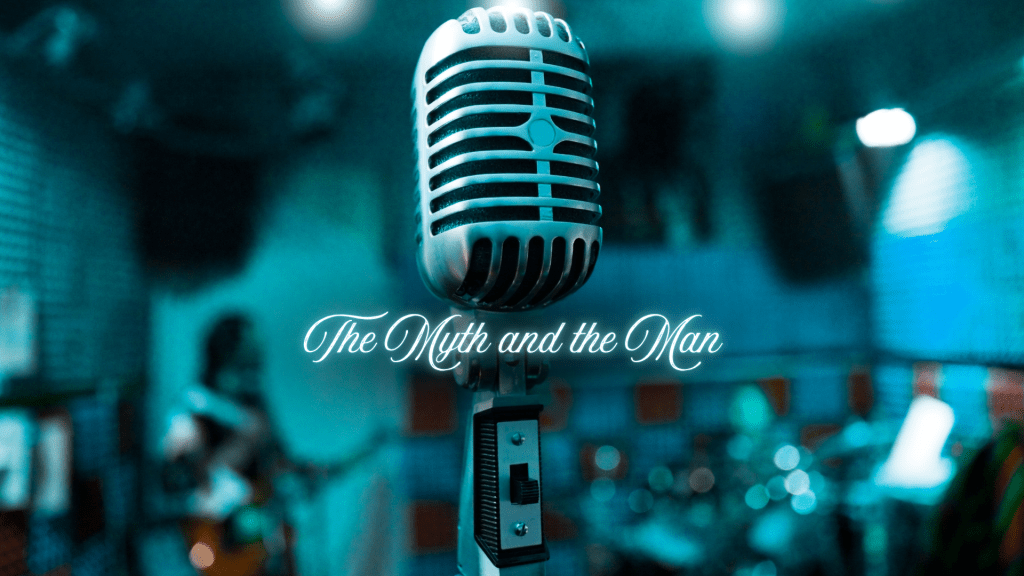 Vintage silver microphone centered against a moody blue-green stage background, with soft blur and glowing script text reading “The Myth and the Man.”