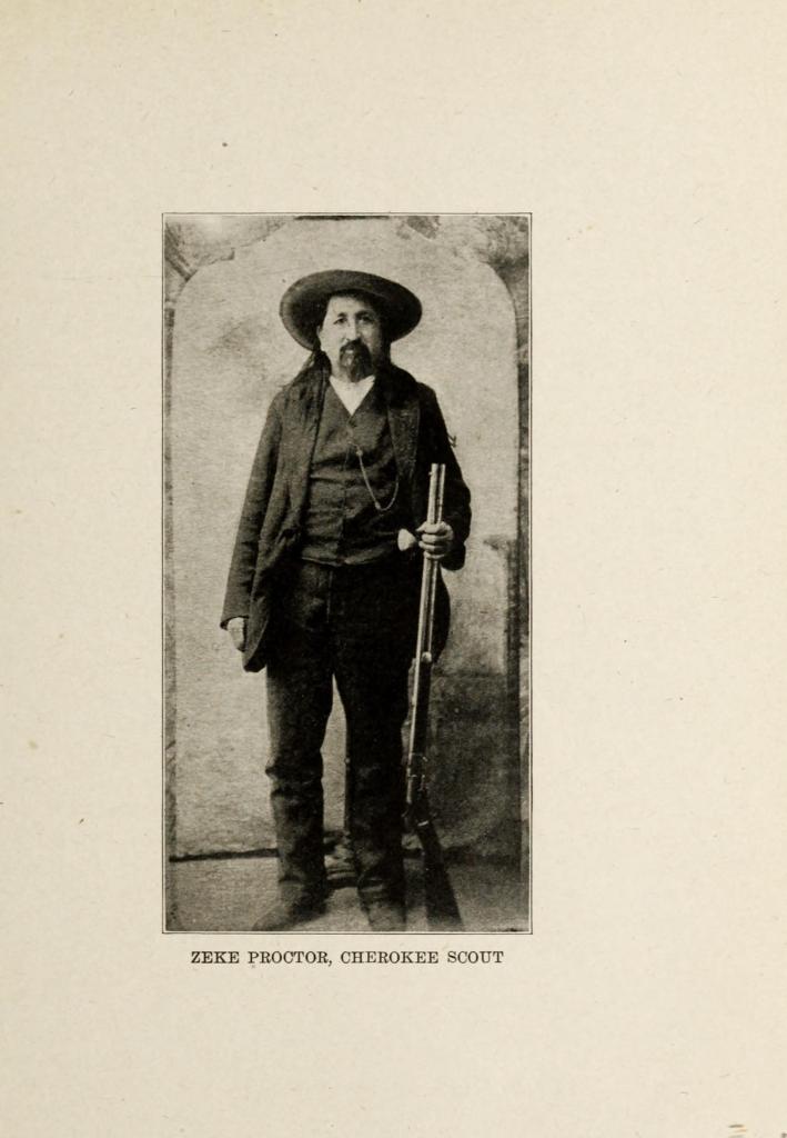 Historic black-and-white image of Ezekiel “Zeke” Proctor standing with a rifle, captioned “Zeke Proctor, Cherokee Scout.”