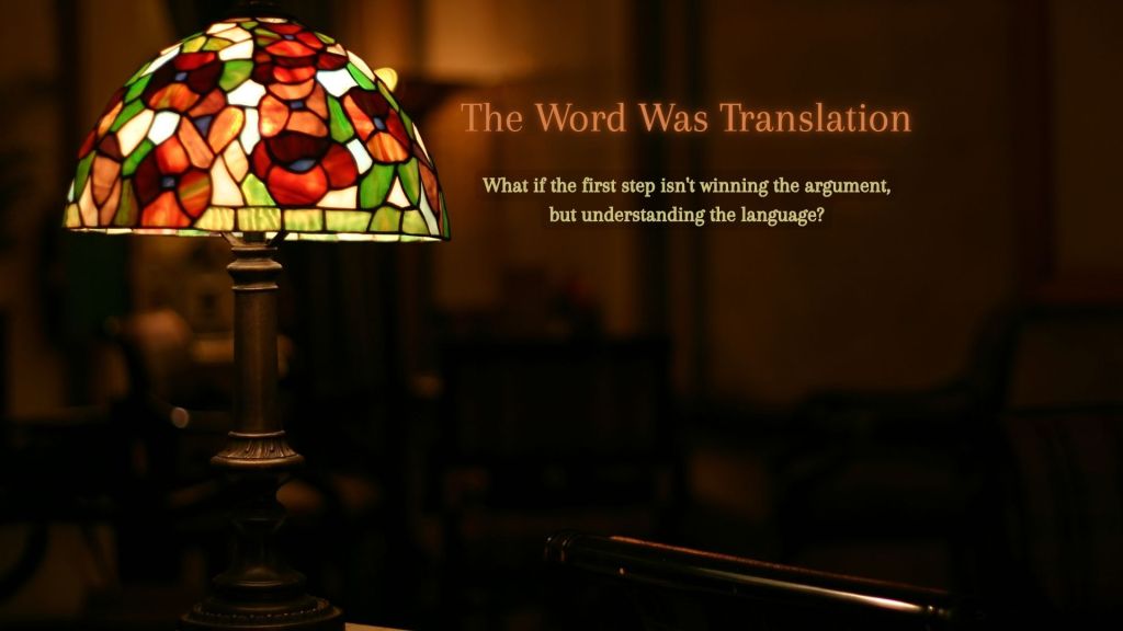 A Tiffany-style stained-glass lamp glows in a quiet, dimly lit room beside the title "The Word Was Translation" and the subtitle "What if the first step isn't winning the argument, but understanding the language?"