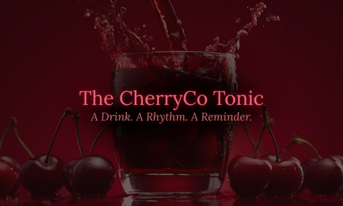 Glass of deep red cherry tonic with splashing liquid against a rich red background, surrounded by fresh cherries, with overlay text reading “The CherryCo Tonic: A Drink. A Rhythm. A Reminder.”