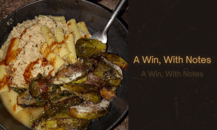 Bowl of garlic Parmesan chicken rigatoni with balsamic garlic Brussels sprouts, Parmesan cheese, and hot sauce, with overlay text reading “A Win, With Notes.”