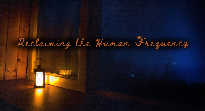 A small lantern glowing warmly on a wooden windowsill at night, casting amber light inside while a deep blue night sky fills the window beyond. The words “Reclaiming the Human Frequency” appear across the image in warm script.