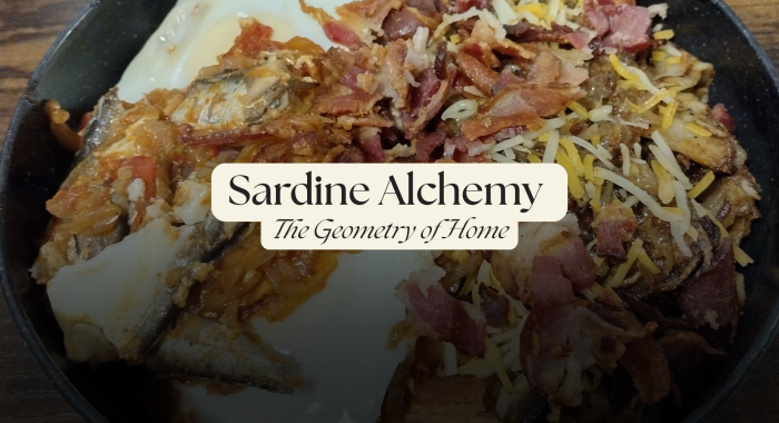 Skillet of sardines and smashed tomatoes topped with soft eggs, crispy bacon, and melted cheese.