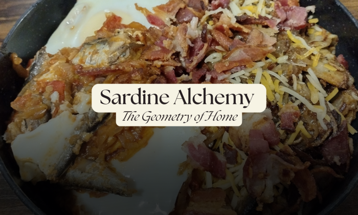 Skillet of sardines and smashed tomatoes topped with soft eggs, crispy bacon, and melted cheese.