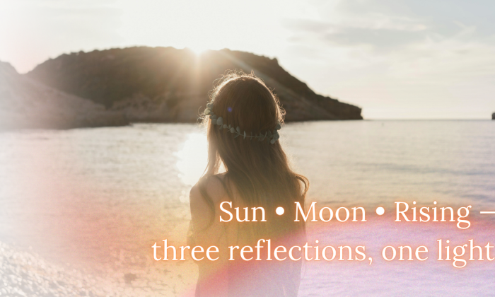 A woman with a flower crown stands at the water’s edge, gazing toward the sun as it reflects over calm waves. The soft golden light evokes unity and self-awareness. The text reads “Sun • Moon • Rising — three reflections, one light.”